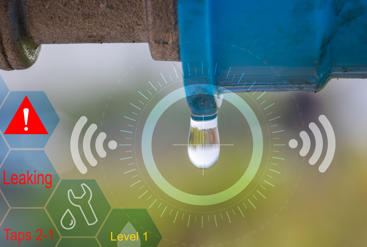 A close-up of a water leak from a pipe, with digital overlays indicating a detection system that identifies leaks and alerts at a specific level.