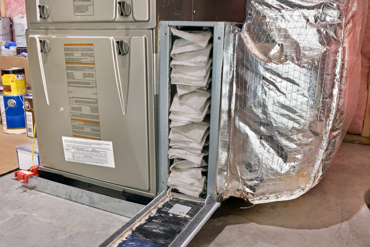 Furnace air filter opened for inspection and cleaning, or replacement.
