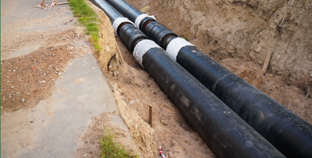 An exposed sewer line that has had repairs made